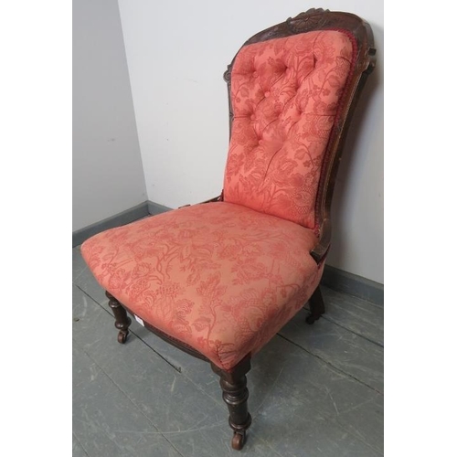 761 - A matched pair of late Victorian mahogany nursing chairs, upholstered in dusky pink patterned materi... 