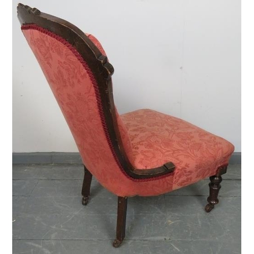 761 - A matched pair of late Victorian mahogany nursing chairs, upholstered in dusky pink patterned materi... 