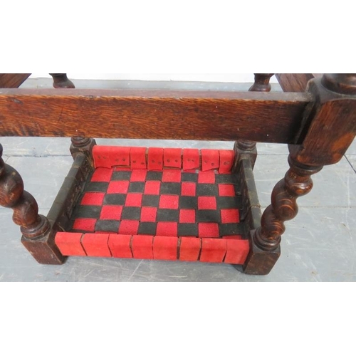 762 - A small vintage oak stool, with black and red strapwork leather seat, on barley twist supports with ... 