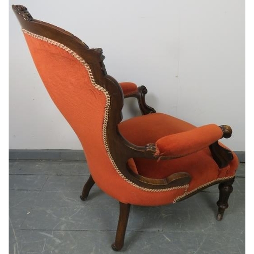 763 - A Victorian mahogany spoon back open sided armchair, upholstered in buttoned red velvet material, on... 