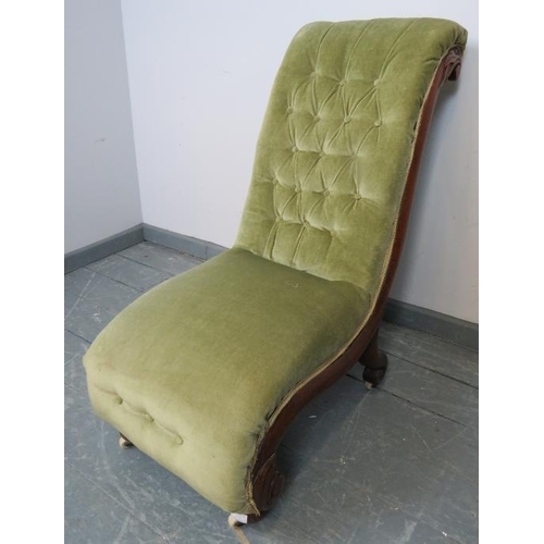 772 - A Victorian mahogany slipper chair, upholstered in buttoned green velvet, on bun feet with ceramic c... 