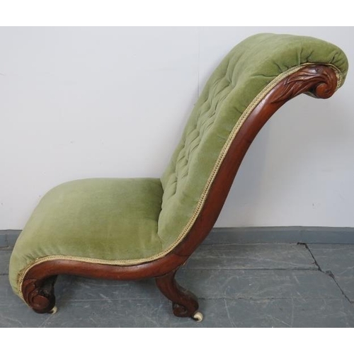 772 - A Victorian mahogany slipper chair, upholstered in buttoned green velvet, on bun feet with ceramic c... 