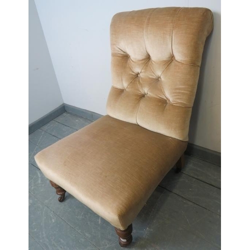 775 - A late Victorian nursing chair, upholstered in buttoned beige draylon material, on tapering turned s... 