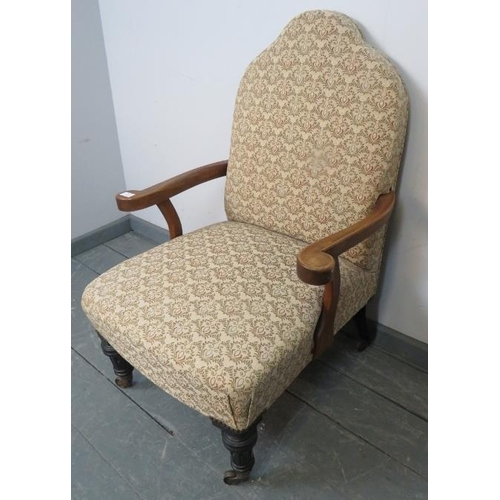 776 - A late Victorian camelback low open sided armchair, upholstered in a patterned material depicting fe... 