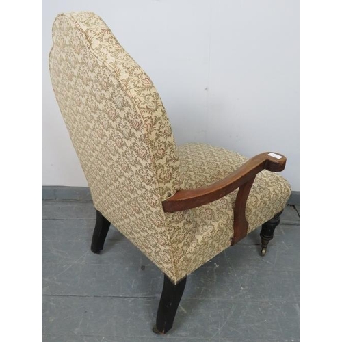 776 - A late Victorian camelback low open sided armchair, upholstered in a patterned material depicting fe... 