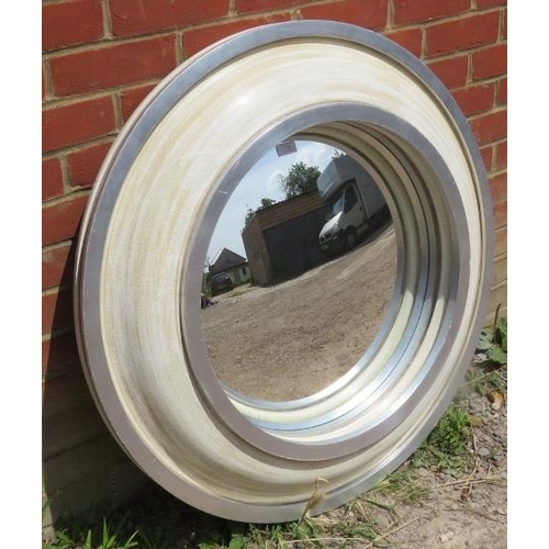 778 - A large contemporary circular, convex wall mirror, in distressed cream and silver surround.
Conditio... 