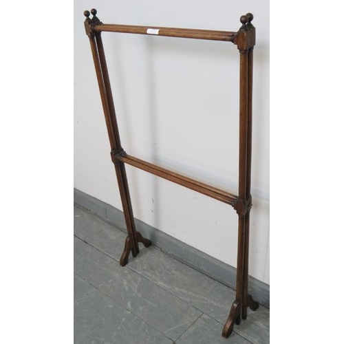 787 - An Edwardian mahogany folding double towel rail, on splayed supports. With brass hook and catch. 
Co... 