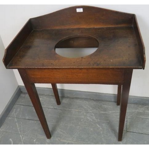 796 - A Georgian country made oak washstand, with shaped ¾ gallery and provision for a sink/basin, on tape... 