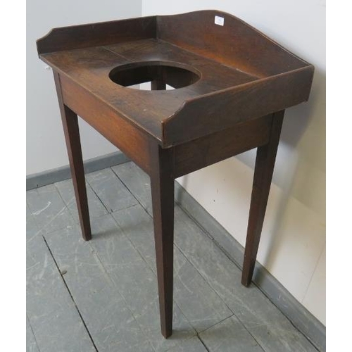 796 - A Georgian country made oak washstand, with shaped ¾ gallery and provision for a sink/basin, on tape... 