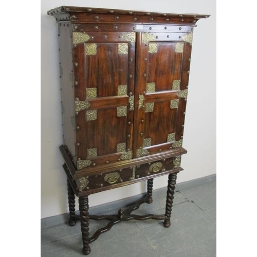 798 - An 18th century and later hardwood Zanzibar cabinet on stand, with ornate brass mounts and studwork,... 