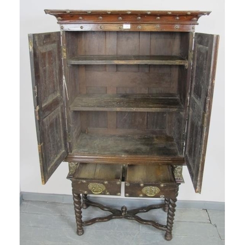 798 - An 18th century and later hardwood Zanzibar cabinet on stand, with ornate brass mounts and studwork,... 