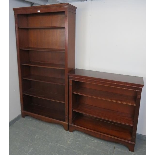 800 - A reproduction mahogany period style tall open bookcase of five height adjustable shelves, flanked b... 