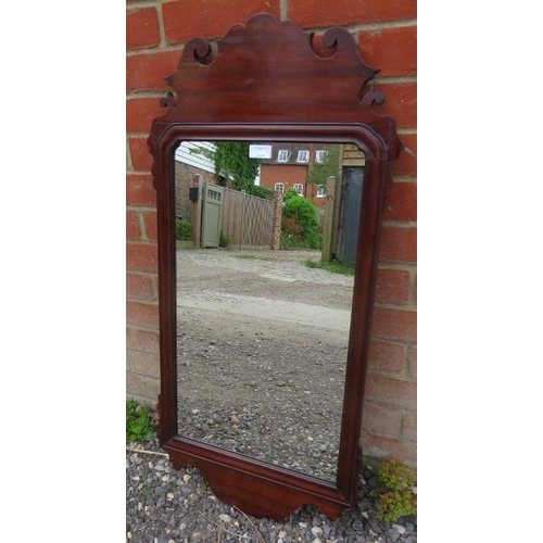 803 - A Georgian mahogany rectangular wall mirror in a shaped and scrolled surround.
Condition report: No ... 