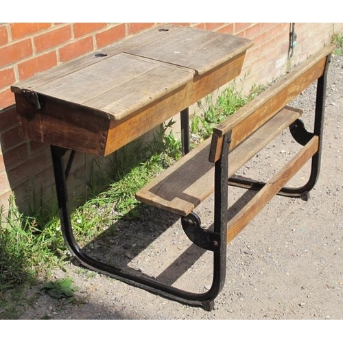 804 - A Victorian/Edwardian beech double school desk, with two rising lids, on cast iron frame. 
Condition... 