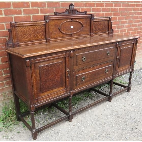 816 - A turn of the century oak sideboard c.1900, with rear gallery carved with Greek key motifs, over two... 