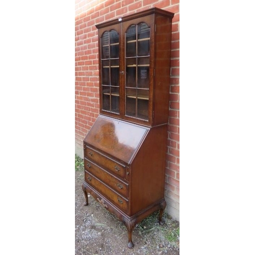 821 - An early 20th century walnut Georgian revival bureau bookcase, on cabriole supports. 
Condition repo... 