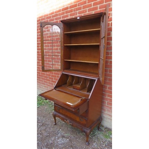 821 - An early 20th century walnut Georgian revival bureau bookcase, on cabriole supports. 
Condition repo... 