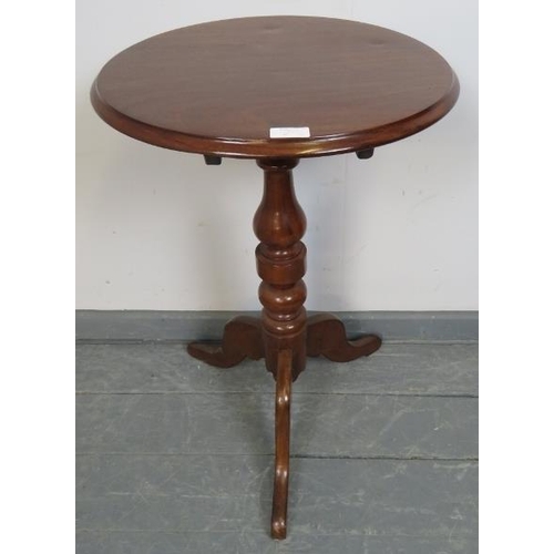 825 - A 19th century mahogany circular tilt top wine table, on a turned pedestal with tripod base. 
Condit... 