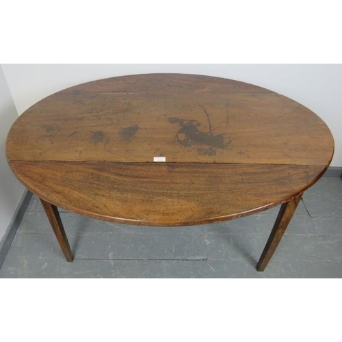 828 - A Georgian mahogany oval Pembroke table, the single drawer with brass lock escutcheon and swan neck ... 