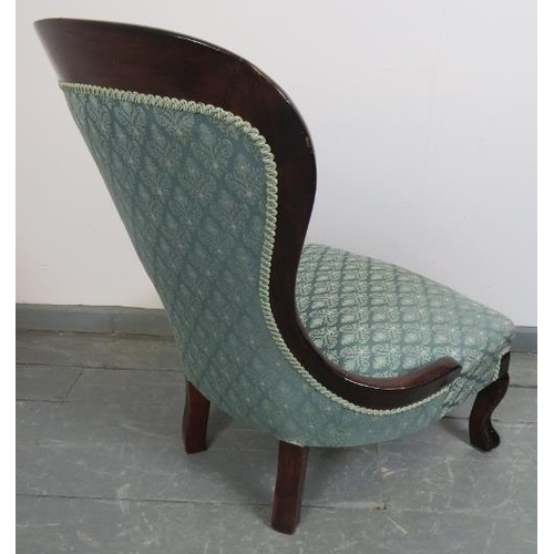 829 - A Victorian mahogany spoonback nursing chair, upholstered in a blue brocade buttoned material, on ho... 