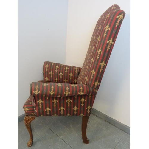 830 - A Georgian Revival highback armchair, upholstered in a claret striped material embroidered with fleu... 