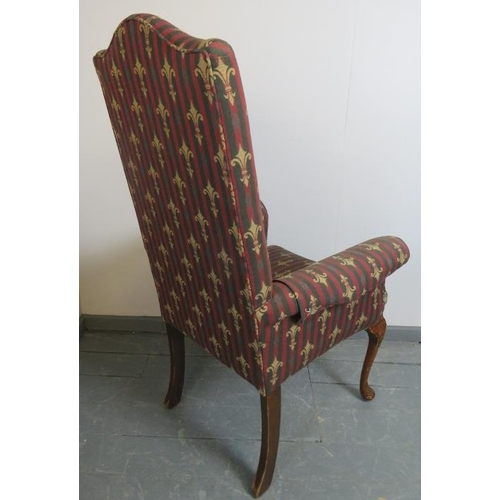 830 - A Georgian Revival highback armchair, upholstered in a claret striped material embroidered with fleu... 