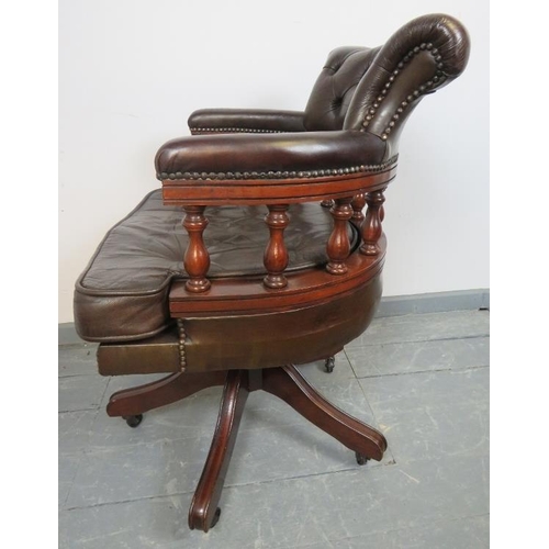 833 - A vintage mahogany captain’s swivel desk chair with height adjust, upholstered in chocolate brown bu... 