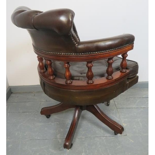 833 - A vintage mahogany captain’s swivel desk chair with height adjust, upholstered in chocolate brown bu... 