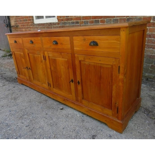 840 - A large contemporary hardwood sideboard of four short drawers with cast scallop handles, over two do... 