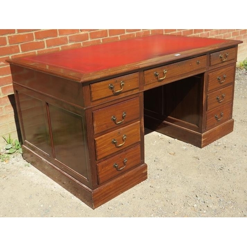 842 - A large vintage mahogany pedestal desk, with inset red leather writing surface, housing a configurat... 