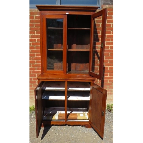 843 - A 19th century walnut glazed bookcase of four height adjustable shelves, with cupboard under housing... 