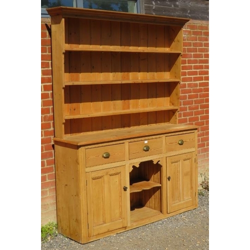 844 - An antique stripped pine ‘dog kennel’ highback kitchen dresser, with plate rack shelving over a side... 