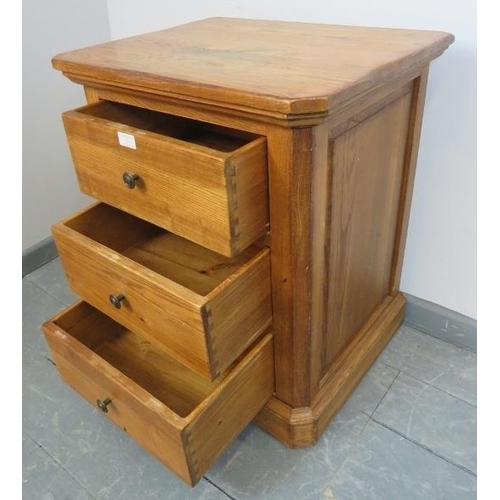 851 - A contemporary light oak bedside chest of three drawers, with fielded side panels, on a plinth base.... 