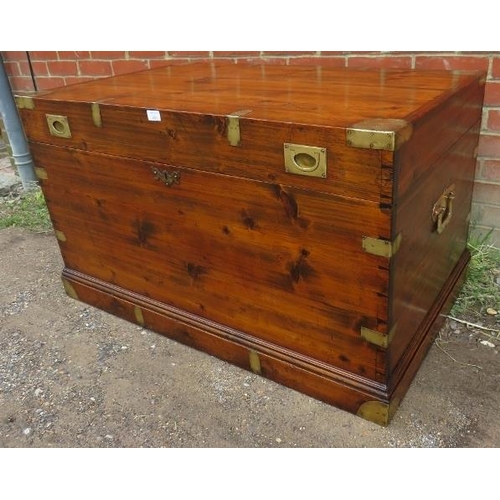 856 - A large 19th century campaign trunk with brass mounts and handles to either side, on a plinth base.
... 