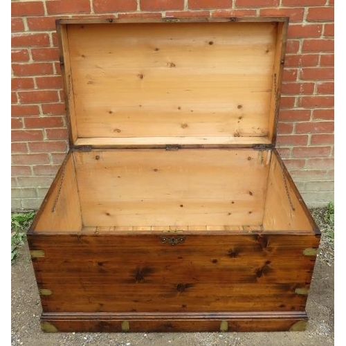 856 - A large 19th century campaign trunk with brass mounts and handles to either side, on a plinth base.
... 