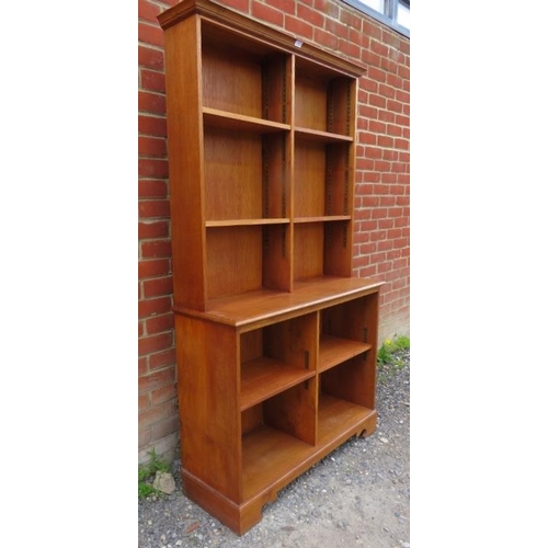 858 - A medium oak tall open bookcase of seven height adjustable shelves, on bracket feet. 
Condition repo... 