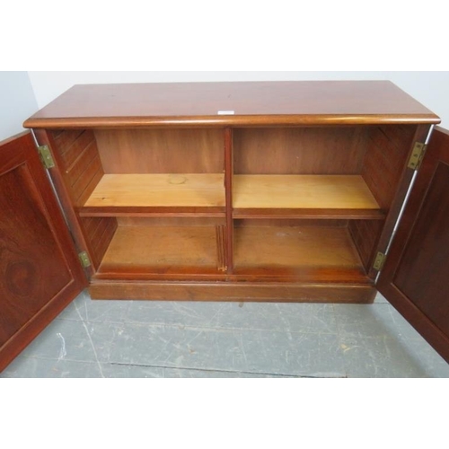 866 - A Victorian mahogany low side cabinet, the panelled doors opening onto two height adjustable shelves... 