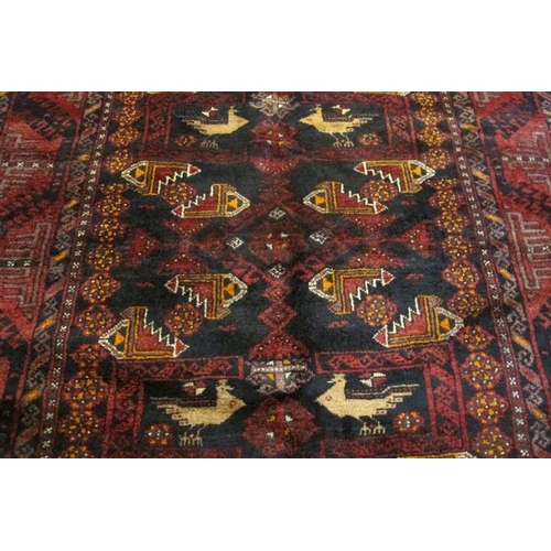 920 - Meshed Belouch rug, a central patterned field with stylised birds, blue/deep red. Good condition and... 