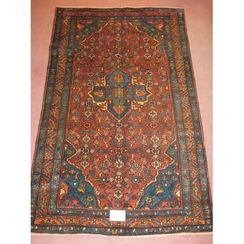 921 - A Malayer rug, blue on red ground. Good clean rug in fine condition. 205cm x 127cm (approx).