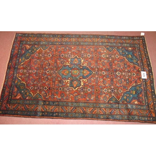 921 - A Malayer rug, blue on red ground. Good clean rug in fine condition. 205cm x 127cm (approx).