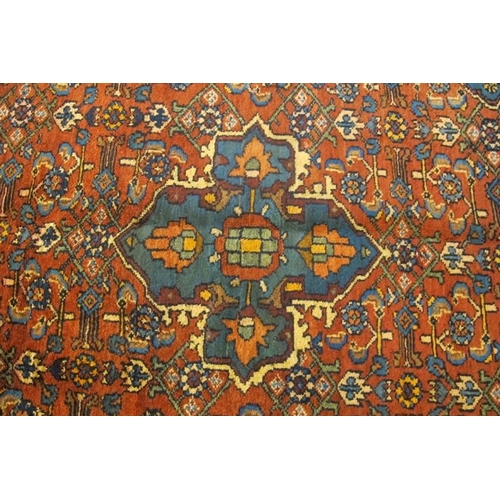 921 - A Malayer rug, blue on red ground. Good clean rug in fine condition. 205cm x 127cm (approx).