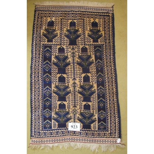 923 - A small Persian rug blue on cream ground. Condition okay. 125cm x 75cm (approx).