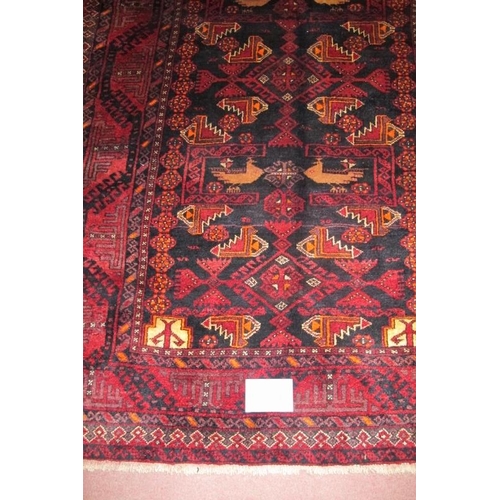 920 - Meshed Belouch rug, a central patterned field with stylised birds, blue/deep red. Good condition and... 