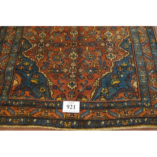 921 - A Malayer rug, blue on red ground. Good clean rug in fine condition. 205cm x 127cm (approx).