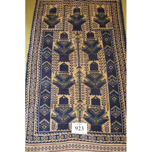 923 - A small Persian rug blue on cream ground. Condition okay. 125cm x 75cm (approx).