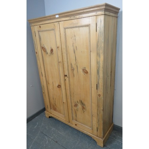 706 - An antique stripped pine pantry cupboard, the double doors opening onto fitted shelves, on bracket f... 