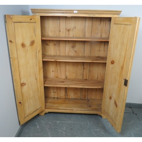 706 - An antique stripped pine pantry cupboard, the double doors opening onto fitted shelves, on bracket f... 