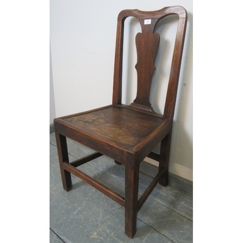 861 - An 18th century Georgian oak hall chair, with shaped back splat, on inner chamfered square supports ... 