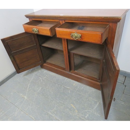 868 - An Aesthetic Period walnut sideboard of two short drawers and two cupboards under, with fitted shelv... 