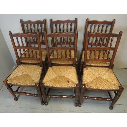 879 - A set of eight (6 + 2) Georgian style Lancashire oak framed spindle back rush seated dining chairs.
... 